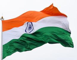 India flag flying high at Connaught Place with pride in blue sky, India flag fluttering, Indian Flag on Independence Day and Republic Day of India, tilt up shot, Waving Indian flag, Har Ghar Tiranga photo