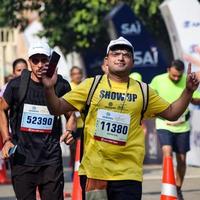 New Delhi, India - October 16 2022 - Vedanta Delhi Half Marathon race after covid in which marathon participants about to cross the finish line, Delhi Half Marathon 2022 photo