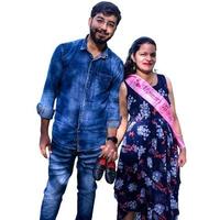 Indian couple posing for maternity baby shoot with white plain background. The couple is posing in a lawn with green grass and the woman is falunting her baby bump in Lodhi Garden in New Delhi, India photo