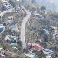 Aerial top view of traffic vehicles driving at mountains roads at Nainital, Uttarakhand, India, View from the top side of mountain for movement of traffic vehicles photo