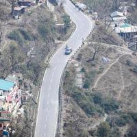 Aerial top view of traffic vehicles driving at mountains roads at Nainital, Uttarakhand, India, View from the top side of mountain for movement of traffic vehicles photo