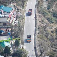 Aerial top view of traffic vehicles driving at mountains roads at Nainital, Uttarakhand, India, View from the top side of mountain for movement of traffic vehicles photo