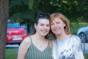 Beautiful senior mother and her adult daughter look at the camera and smile photo