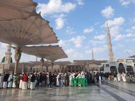 Medina, Saudi Arabia, Dec 2022 - During the day pilgrims from all over the world gather in the outer courtyard of Masjid Al Nabawi, Medina, Saudi Arabia. photo