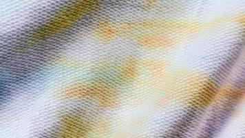 white cloth texture with yellow and blue patterns as background photo
