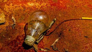 Light bulb on rusty zinc as a background photo