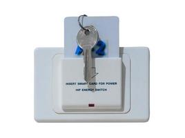 Smart card with key inserted into white socket with text reading Insert smart card for power installed on white wall in luxurious hotel or resort room isolated on white background with clipping path photo