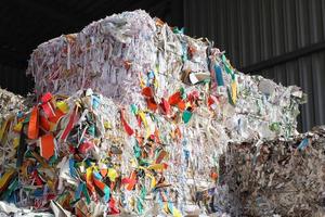 Wastepaper compact texture pile for recycling on sorting plant. Technology of reuse materials. Stack of shredded paper. Save the planet ecology concept. Industry of reduced pollution factory. Close-up photo