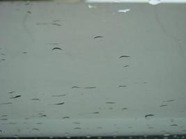 rainy days rain drops on the window surface photo