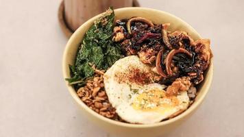 a glass of coffee with ice and boiled noodles filled with eggs and vegetables photo