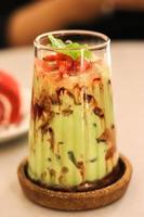 High-angle view of close-up of Juice with avocado on table photo