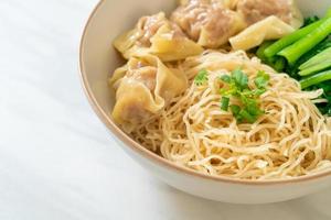 dried egg noodles with pork wonton or pork dumplings without soup photo