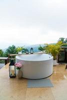 outdoor bath tub with beautiful mountain view background photo
