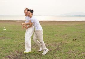 Happy young Asian couple in bride and groom t-shirt photo