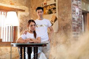 Happy young Asian couple in bride and groom t-shirt photo