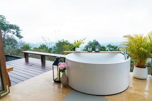 outdoor bath tub with beautiful mountain view background photo