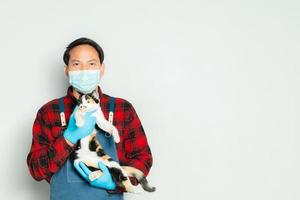 Pet owner affectionately holds a cat of 3 colors. photo