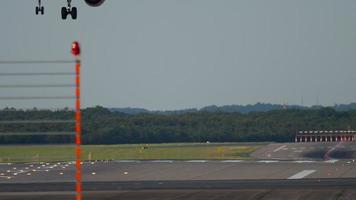 Airplane landing at 05R runway Dusseldorf airport, evening sunset rays video