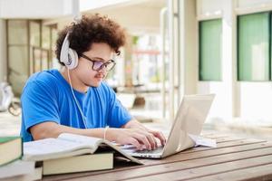 Attractive young people using a laptop and tutoring together, Social media online concept photo