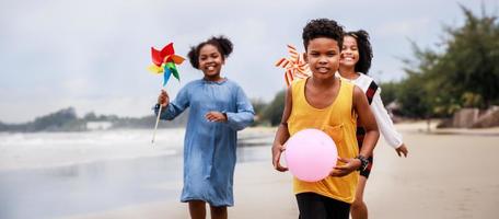 Children having fun on the beach. Diversity concept. Happy Group of African American kids photo