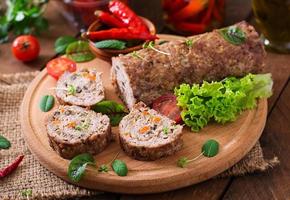 Minced meat loaf roll with mushrooms and carrots photo