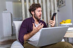 Business man at home on mobile yelling and screaming about bad report and failure with project, mad boss angry about software bugs in application for work photo