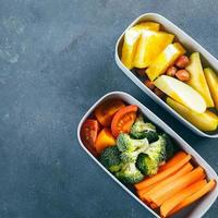 Lunch box with vegetables and fruits. Delicious balanced food concept. Top view, crop square image photo