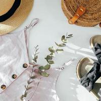 Beauty blog concept. Summer female clothes, accessories. Black sandals, top, straw hat, rattan bag photo