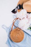 Stylish female hat, dress, rattan bag, suneyeglasses, peony. Women's fashion summer accessories. photo