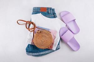 Casual women's clothing, acccessories. T-shirt, summer slippers, shorts, organic rattan bag photo