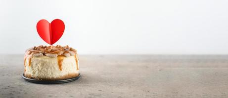 Small bento cheesecake decorated with small hearts topper. Valentine's day concept. Banner image photo