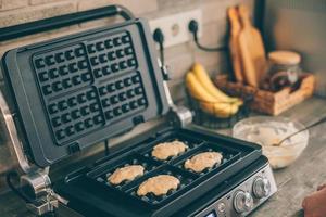 Process of preparing Belgian waffles in the kitchen. Cooking process photo