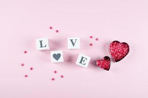 Heart Candy and Cubes Word Love. Valentine's Day Concept. Flat lay, top view, copy space photo