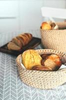 Assortment of bread - gluten-free, corn, rye bread in jute craft basket. Home bakery, home cooking photo