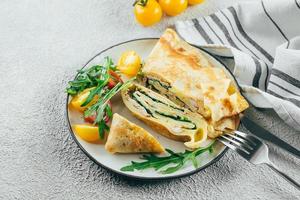 Crepes with stuffed cream cheese, spinach, turkey. Cuisine meal food concept. photo