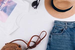 Overhead summer still life. Casual women's clothing, accessories. Vacation, travel concept. Top view photo