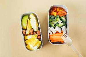 Lunch boxes with vegetables and fruits. Delicious balanced food concept. Healthy living concept photo