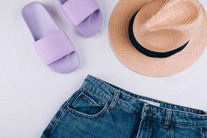 Casual women's clothing, acccessories. Summer slippers, shorts, straw hat photo