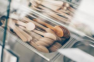 Many wooden spoons and forks in metal container. Concept of zero waste, eco friendly, organic items photo