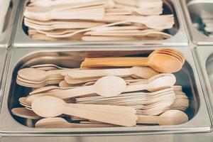 Many wooden spoons and forks in metal container. Concept of zero waste, eco friendly, organic items photo