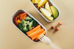 Lunch boxes with vegetables and fruits. Delicious balanced food concept. Healthy living concept. photo