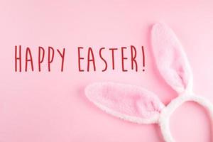 Happy Easter background. Greeting Card. Bunny rabbits on pink background. Easter minimal concept photo