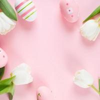 Flat lay composition with painted Easter eggs on pink background. Easter holiday concept. photo