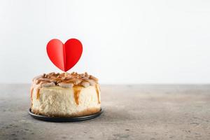 Small bento cheesecake decorated with small hearts topper. Valentine's day concept. photo