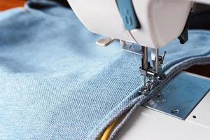 sewing machine. the process of sewing a decorative cord of blue fabric. photo