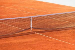 Empty Clay Tennis Court and Net photo