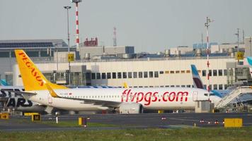 DUSSELDORF, GERMANY JULY 21, 2017 - FlyPegas Boeing 737, TC IZE taxiing to terminal after landing. Dusseldorf airport, Germany video