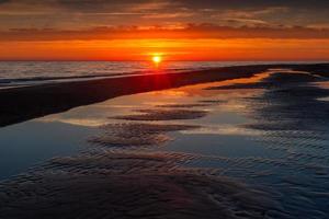 Patterns in the Sea Sand at Sunset photo