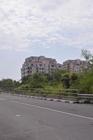 view of a busy highway with trees by the side of the road during the day photo