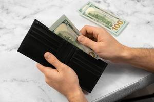 banknote money in a wallet on a light background, the concept of saving money and business growth photo
